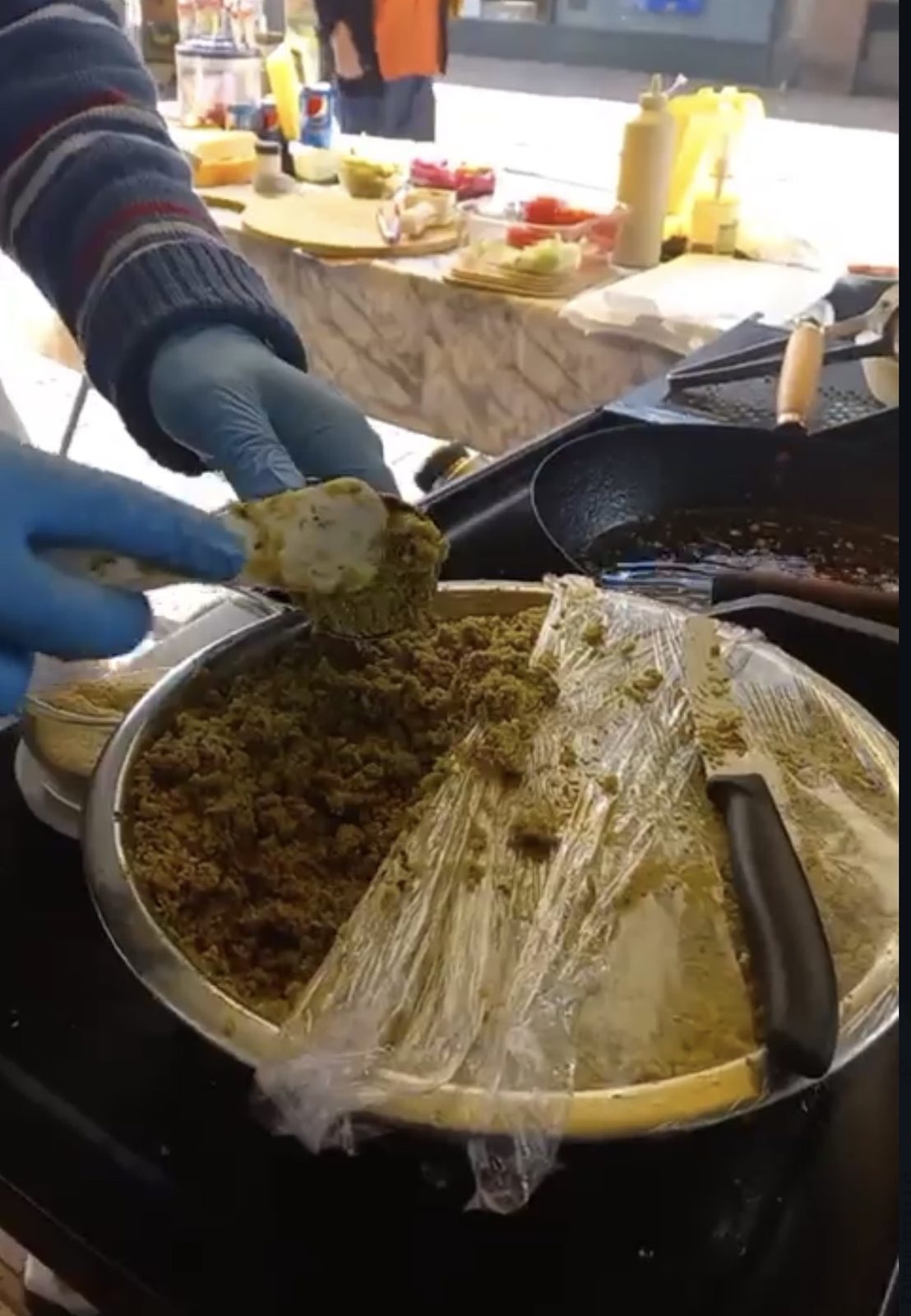 Falafel mixture being prepared by hand at the stall